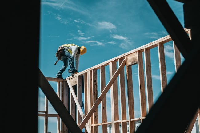 construction worker walking on top of walls